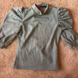 Elegant Green Top with Pearl Accents- small makeup stain